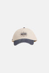 Casquette beige par ACCESSORIES BY JACK & JONES avec visière bleu délavé et logo "Archive" noir.