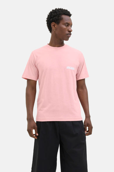 T-shirt rose à manches courtes de JACK & JONES, porté avec un pantalon noir ample.