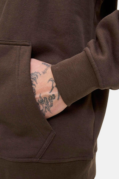 Sweat à capuche kaki de JACK & JONES, avec une main tatouée dans la poche avant, poignet élastique.