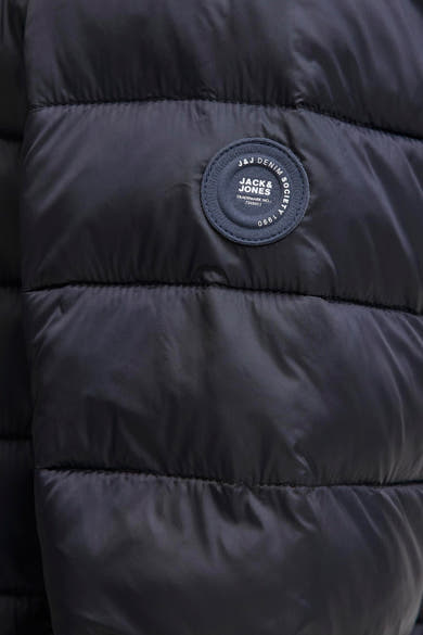 Veste de pluie noire par Jack & Jones, avec texture matelassée et logo sur le devant.
