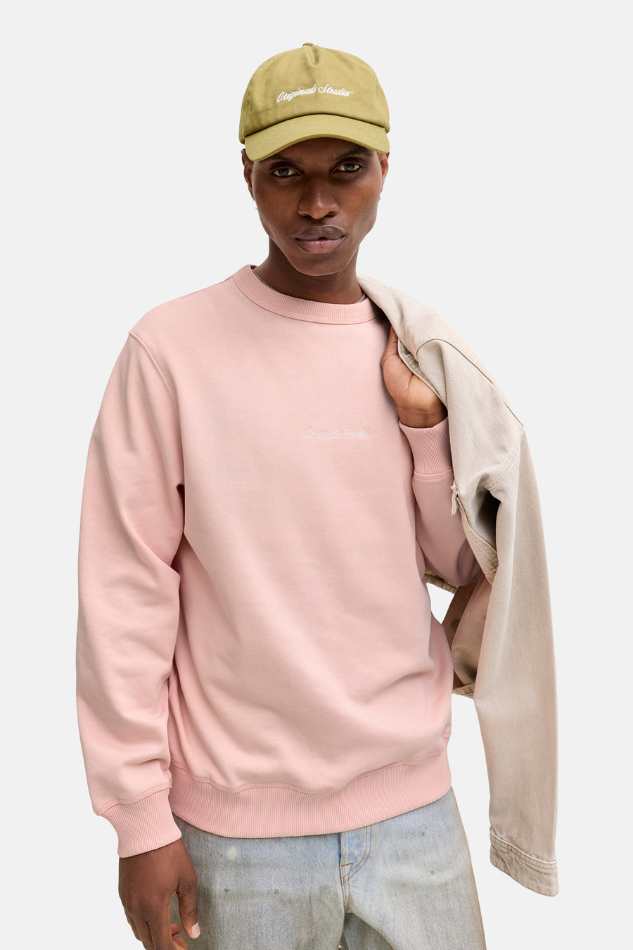 Roze sweatshirt van ORIGINALS BY JACK & JONES, gedragen met een olijfgroene pet en een beige jas.