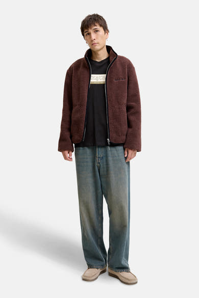 Zwart T-shirt met korte mouwen van ORIGINALS BY JACK & JONES, gedragen met een bruine fleecetrui en een wijde blauwe spijkerbroek.