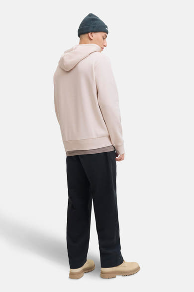 Beige hoodie van JACK & JONES, gedragen met een antracietgrijze muts en een zwarte broek.