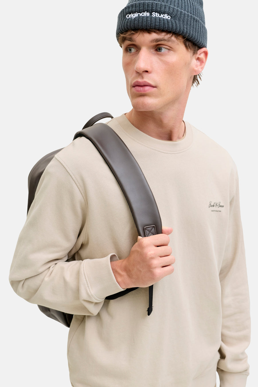 Sweat-shirt beige par ORIGINALS BY JACK & JONES, porté avec un bonnet gris et un sac à dos marron.