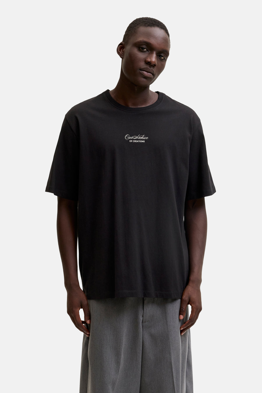 T-shirt noir d'ORIGINALS BY JACK & JONES avec inscription blanche "Our Archive OF CREATIONS" sur la poitrine.