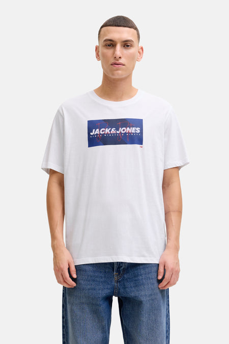 Wit T-shirt met korte mouwen van JACK & JONES, gedragen met een blauwe spijkerbroek en beige bootschoenen.
