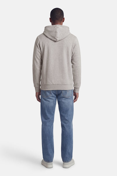Sweat à capuche gris de PREMIUM by JACK & JONES, avec manches longues, porté avec un jean bleu et des baskets grises.