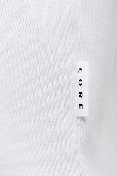 T-shirt blanc à manches courtes de JACK & JONES, avec étiquette verticale portant le mot « CORE ».