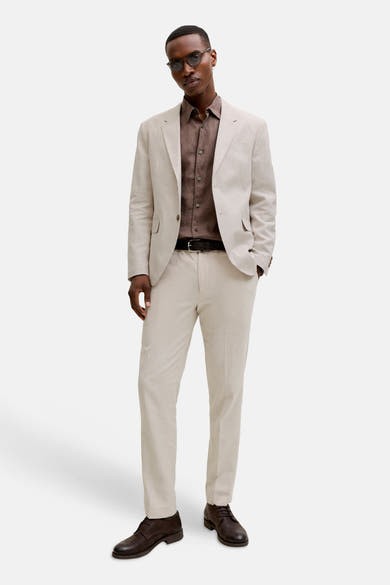 Pantalon de costume écru de PREMIUM by JACK & JONES en tissu texturé, porté par un homme avec un blazer assorti.