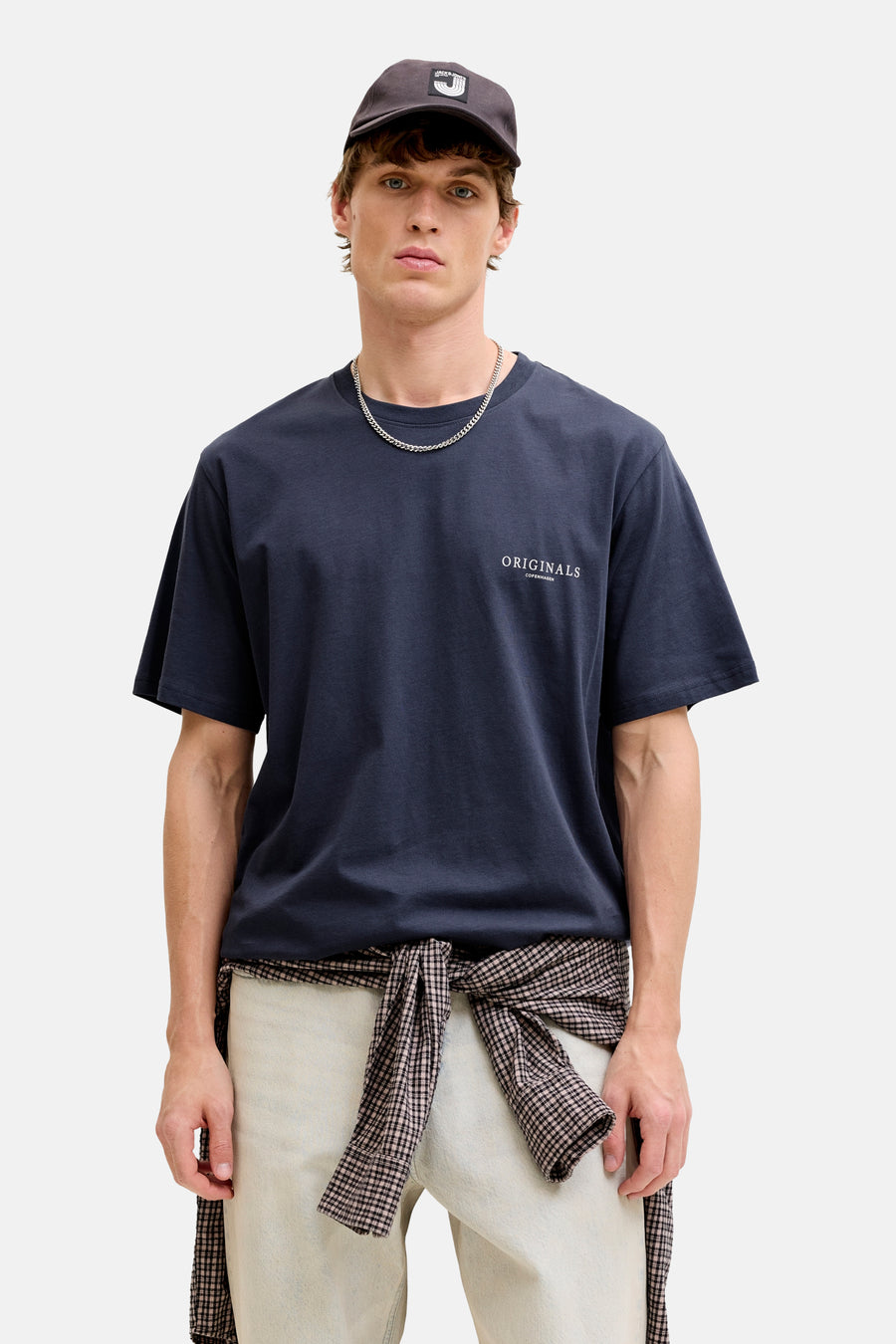 Blauw T-shirt met korte mouwen van ORIGINALS BY JACK & JONES, met opdruk, gedragen met een lichte broek en een geknoopt geruit overhemd.