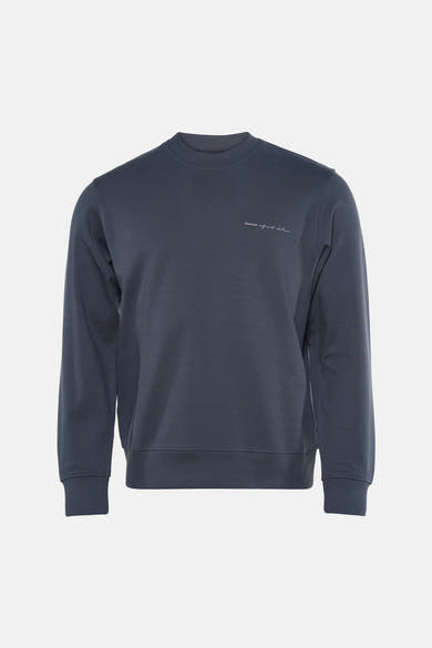 Navy blue crewneck sweatshirt with ribbed cuffs and hem, featuring small white embroidered text on chest, front view.