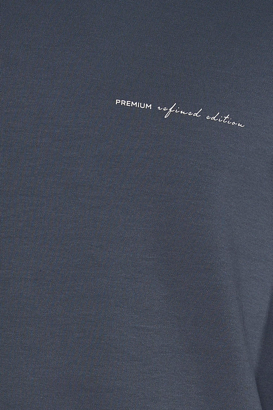 Navy blue crewneck sweatshirt with white embroidered "PREMIUM refined edition" text on chest, close-up view