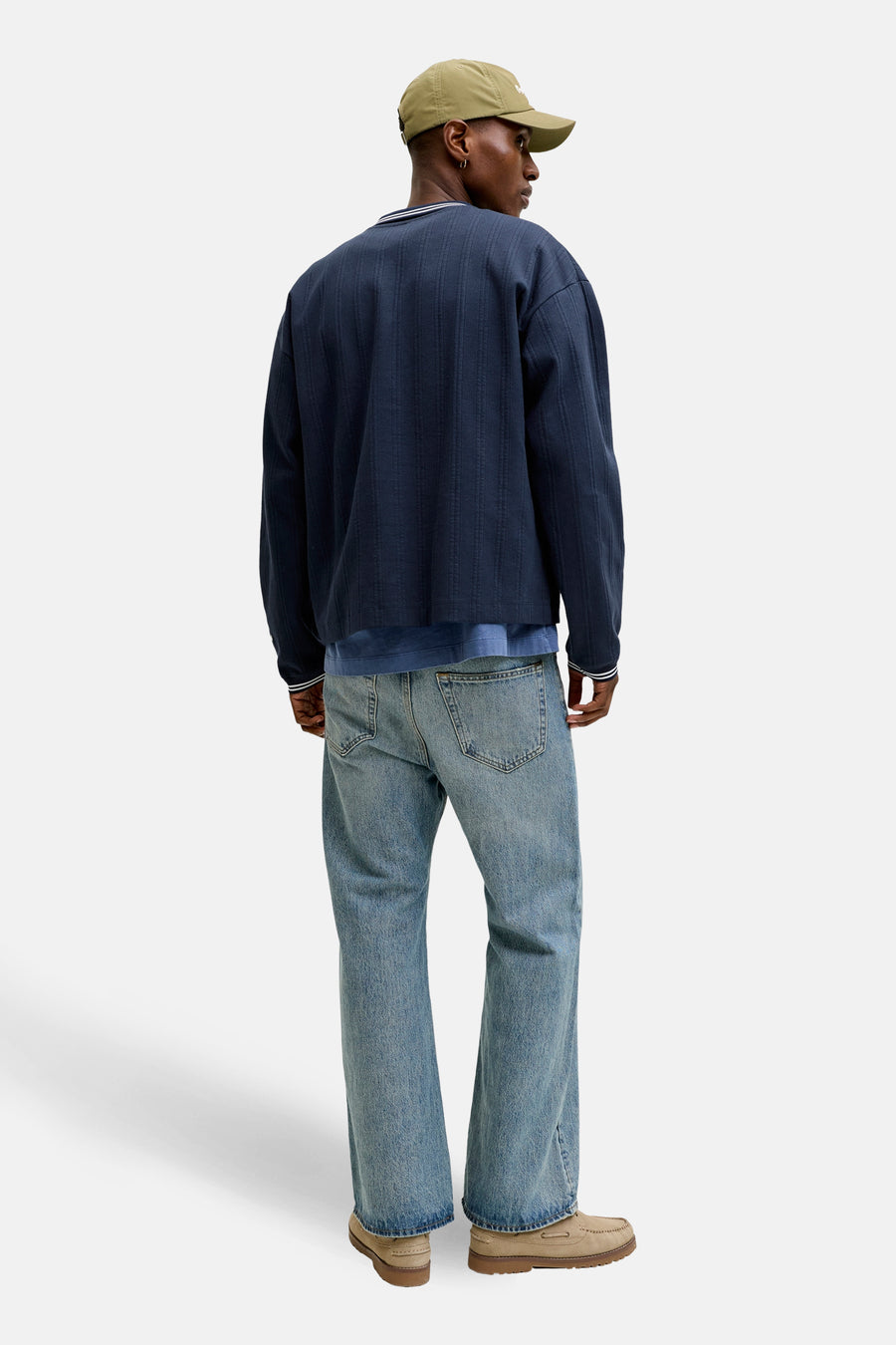 Blauwe sweater van ORIGINALS BY JACK & JONES, met een gestreepte geribde kraag en manchetten, gedragen met een spijkerbroek en beige schoenen.