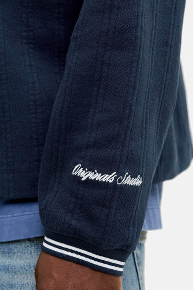 Blauwe sweater met ronde hals van ORIGINALS BY JACK & JONES met 'Originals Studio' borduursel en gestreepte manchetten.