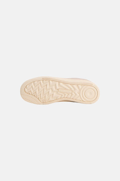 Beige sneakers by Jack & Jones, bottom view showing zigzag tread pattern and circular heel design