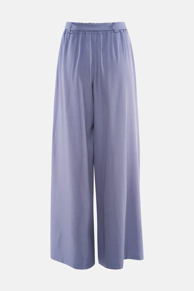 Pantalon costume bleu Terra di Siena, ample et fluide, avec une taille élastiquée, sur un fond neutre.
