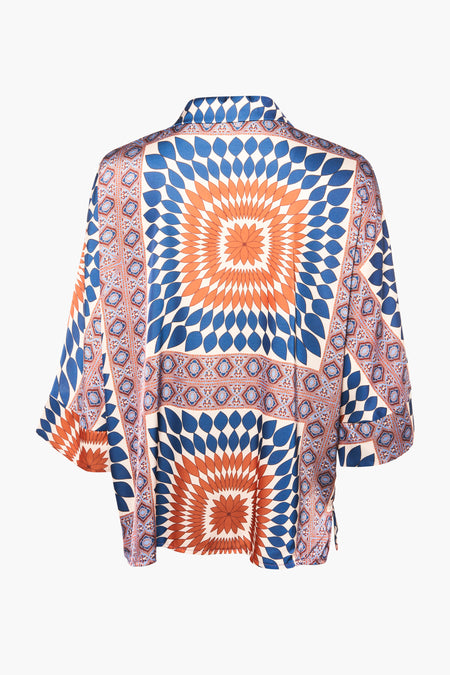 Multicolor long-sleeve blouse with blue and orange geometric pattern, back view, featuring floral medallions and border designs