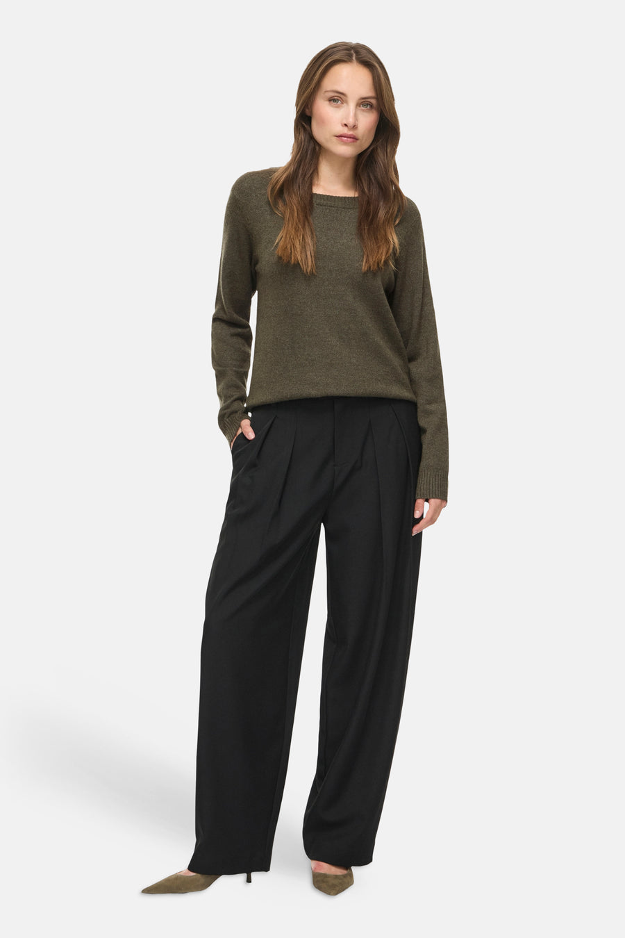 Olive green ribbed knit pullover with round neckline and long sleeves, worn with black wide-leg trousers and olive suede heels, front view.