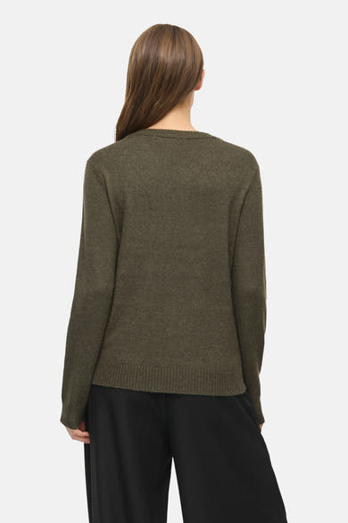 Olive green knit pullover with ribbed hem and cuffs, back view, worn with black wide-leg trousers