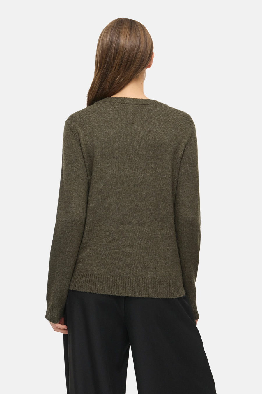 Olive green knit pullover with ribbed hem and cuffs, back view, worn with black wide-leg trousers