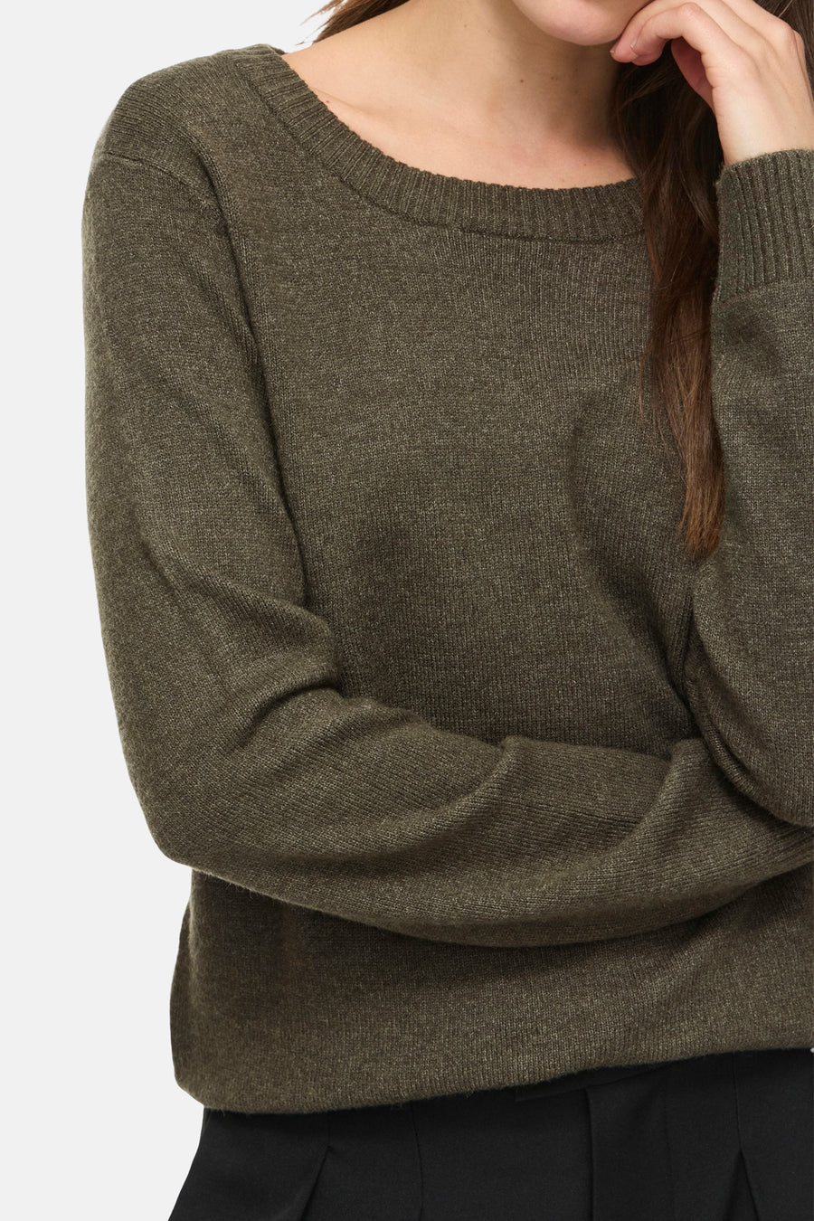 Olive green ribbed knit sweater with round neckline and long sleeves, cropped front view on model wearing black pants