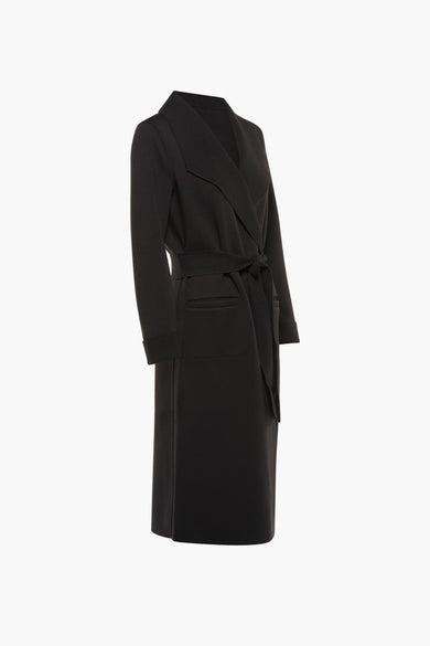 Longue veste noire de VILA, avec ceinture à nouer et poches plaquées.