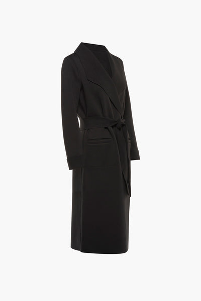 Longue veste noire de VILA, avec ceinture à nouer et poches plaquées.
