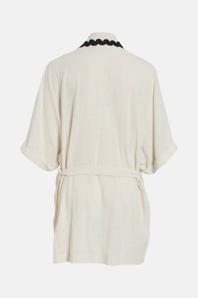 Gilet beige de VILA, avec encolure festonnée noire et manches courtes à revers.