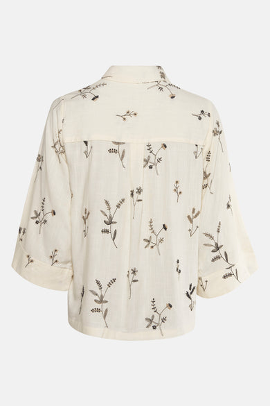 Blouse beige à manches longues de VILA®, ornée de broderies florales délicates sur toute la surface.
