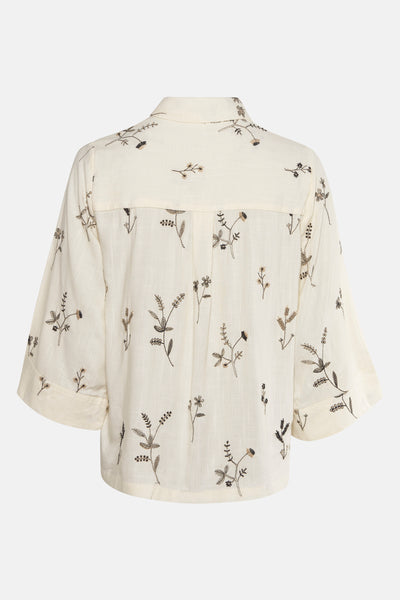 Blouse beige à manches longues de VILA®, ornée de broderies florales délicates sur toute la surface.
