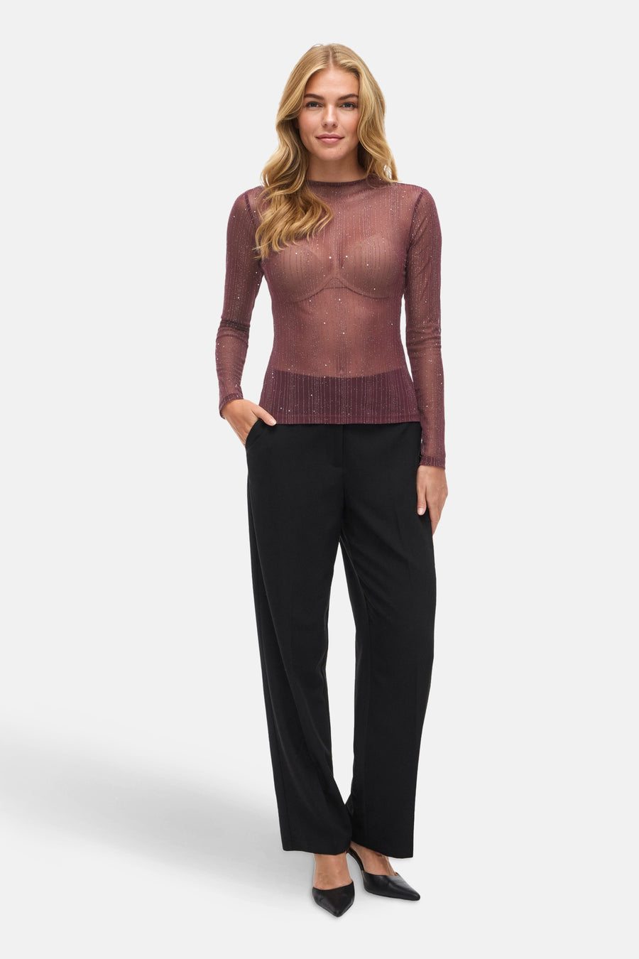 Bordeaux T-shirt met lange mouwen van VILA, gedragen met een zwarte broek en zwarte pumps.