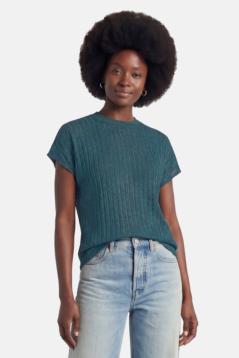 Teal ribbed short-sleeve t-shirt with round neckline, worn with light blue jeans, front view
