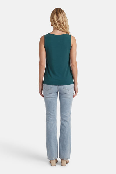 Top sans manches vert de VILA, vu de dos, porté avec un jean délavé et des sandales à talons bloc beige.