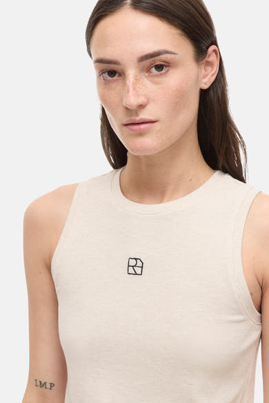Top sans manches beige de ROUGE EDIT, en maille côtelée avec logo discret brodé.