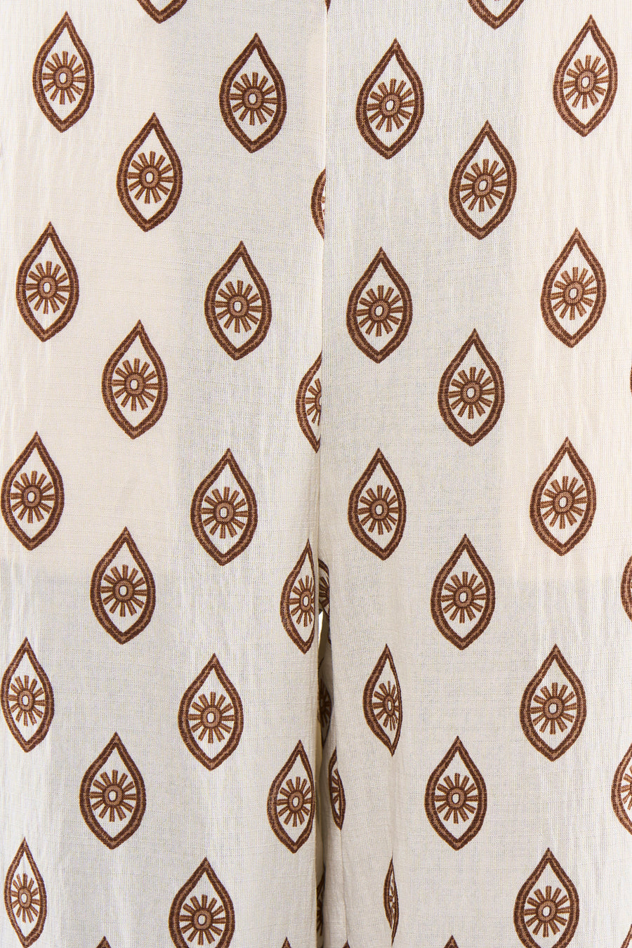 Pantalon beige à motifs marron de VILA® avec imprimé de larmes et de soleils stylisés.