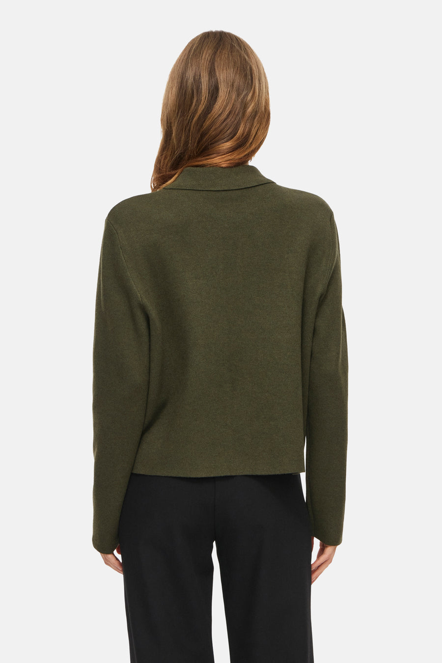 Olive green ribbed cardigan with stand collar, back view, worn with black trousers