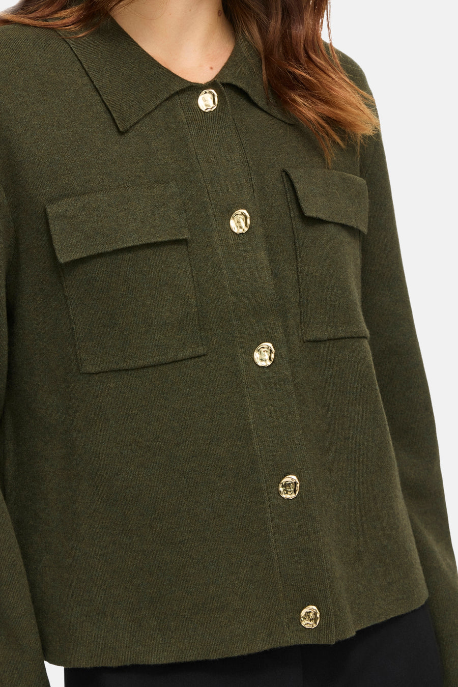 Olive green knit cardigan with gold buttons and flap pockets, front view, cropped close-up