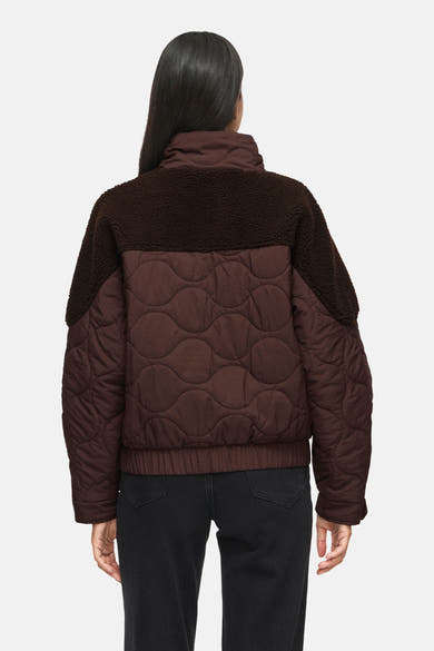 Veste courte marron matelassée par VILA®, dos avec panneau en fausse fourrure, vue arrière sur modèle portant jean noir