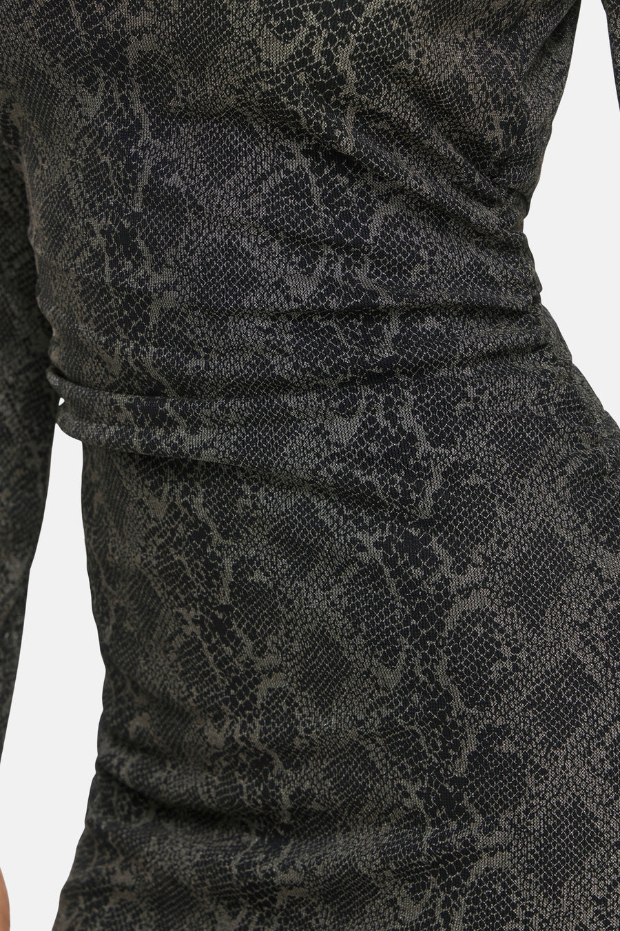 Black long-sleeve dress with snakeskin pattern and ruched waist, side view close-up