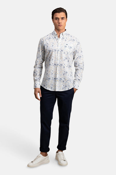 Chemise à manches longues multicolore de FYNCH-HATTON, à motif floral, portée avec un pantalon bleu marine et des baskets blanches.