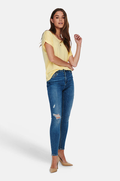 Pale yellow short-sleeve t-shirt with relaxed fit and rounded neckline, worn with distressed blue jeans and beige heels in full-length lifestyle view