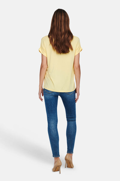 Pale yellow short-sleeve t-shirt from back view, worn with blue jeans and beige heels, smooth cotton fabric, relaxed fit