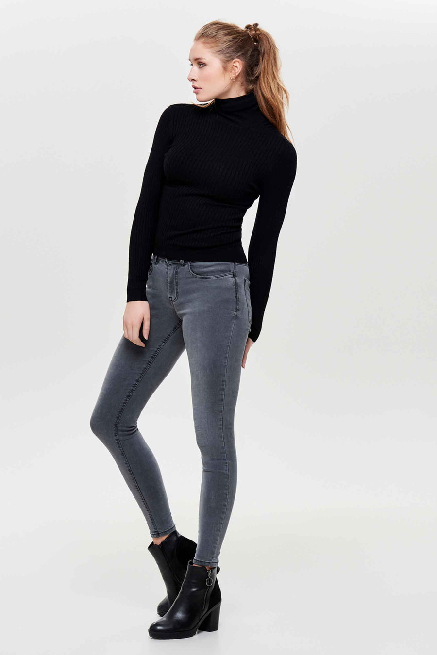 Pull col montant noir de ONLY®, porté avec un jean gris et des bottines noires à talons.
