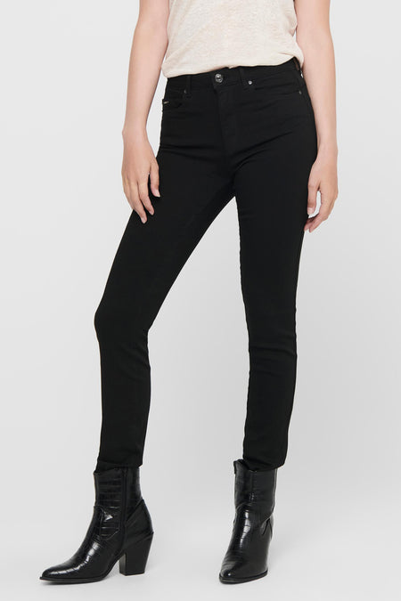 Jean skinny noir de ONLY, porté avec des bottines à motif crocodile.
