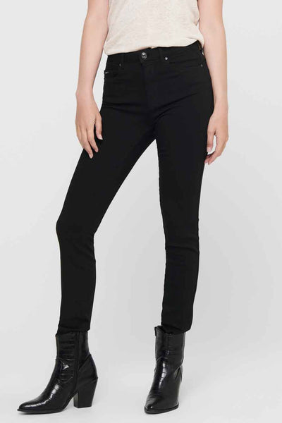 Jean skinny noir de ONLY, porté avec des bottes en cuir façon croco.
