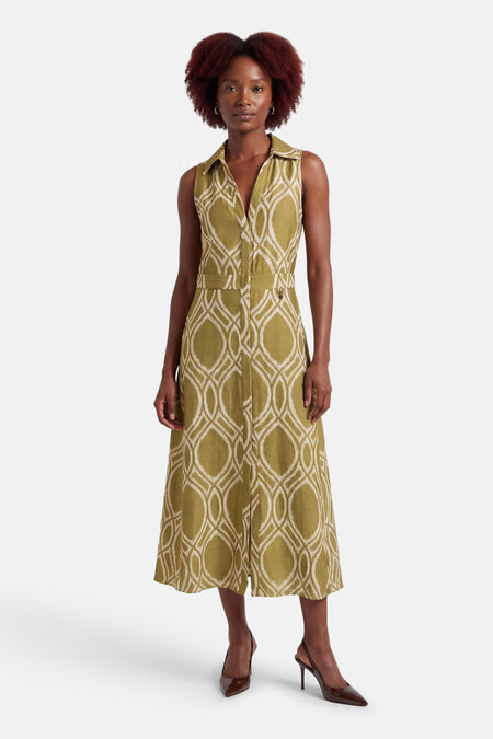 Groene GOA GOA jurk met geometrisch patroon, midi-snit, gedragen met bruine pumps.
