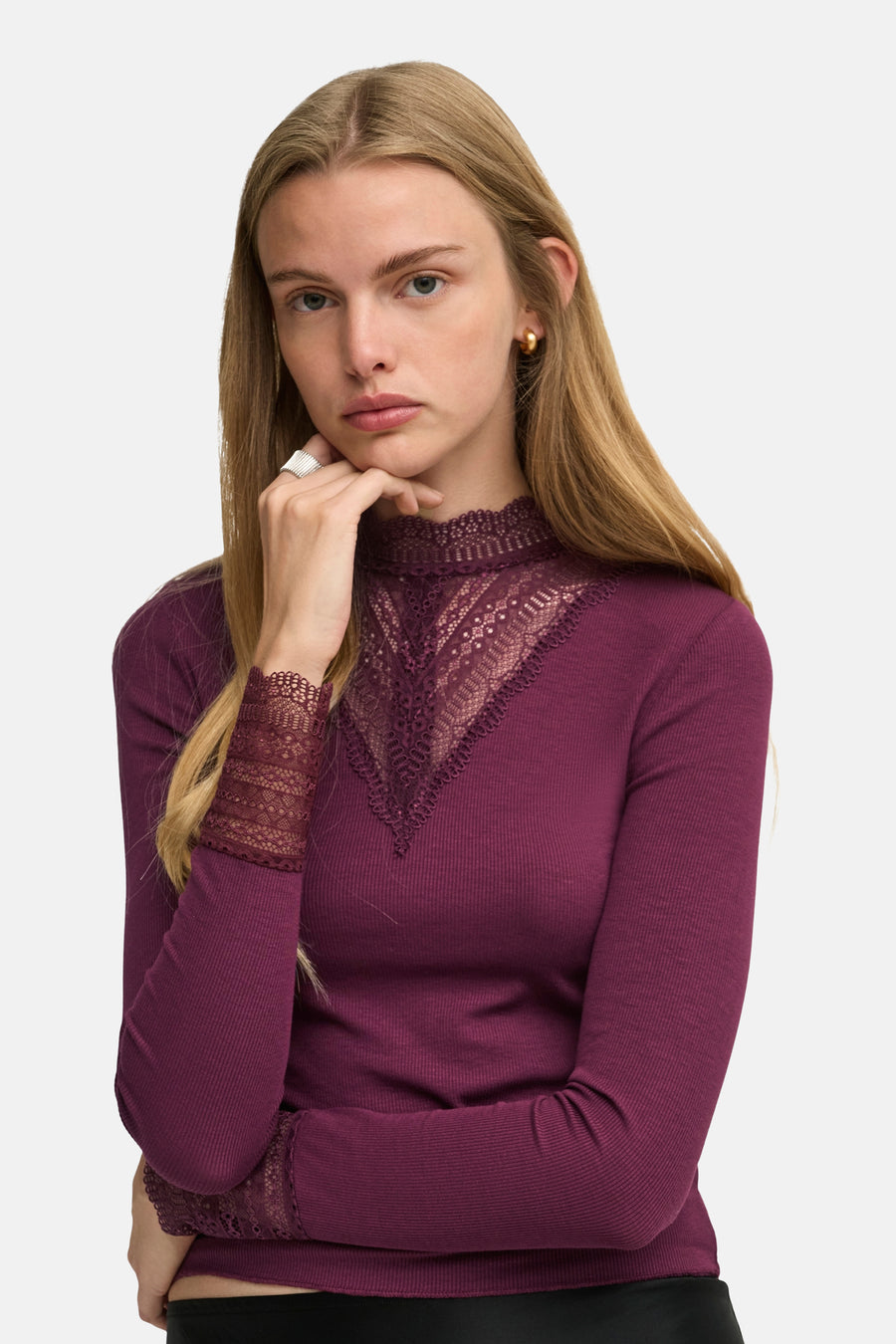 Deep purple long-sleeve ribbed top with lace V-neck and cuffs, worn by model in front view
