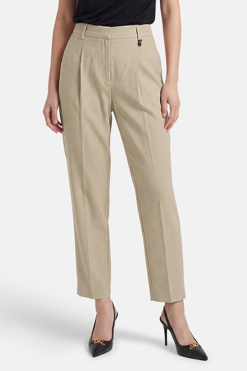 Pantalon de costume beige de GOA GOA, plissé sur le devant avec un détail métallique doré à la taille.
