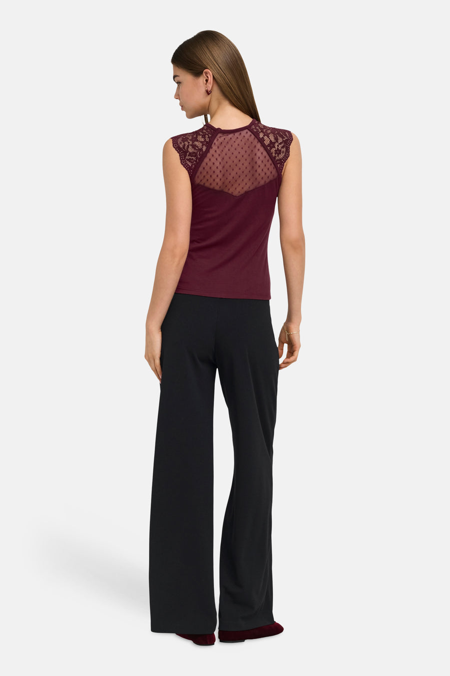 Black wide-leg elastic waist trousers, back view, smooth fabric, worn with burgundy lace-back top and matching shoes