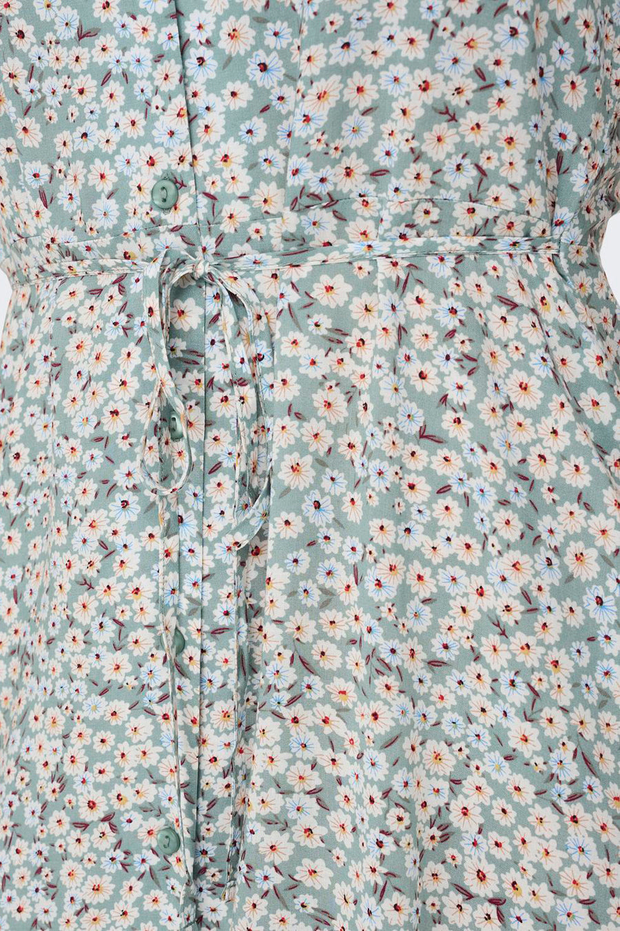 Lichtgroene jurk van ONLY® met witte en blauwe madeliefjesprint, knoopsluiting en strikceintuur in de taille.